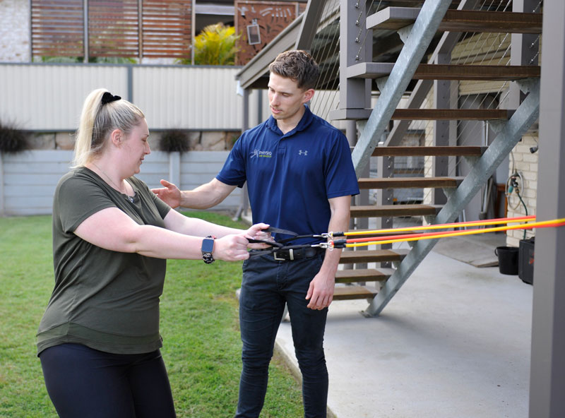 Physio on Wheels clinician supporting a client during treatment